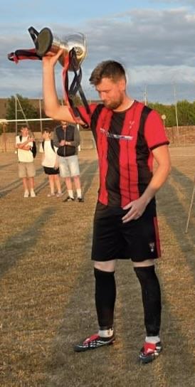Goodwick skipper Scott Delaney holds the Jubilee Cup aloft